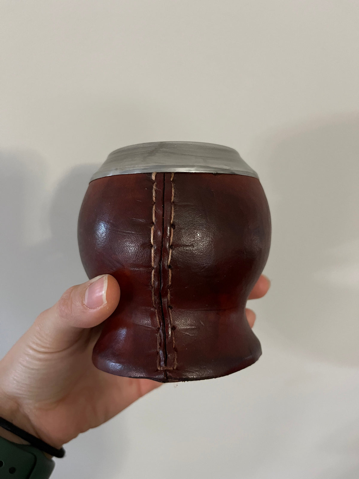 Back of the brown calabash mate cup from the Starter Kit, showing the stitched leather seam