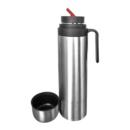 Stainless steel thermos with cap sitting on the left and red pouring spout