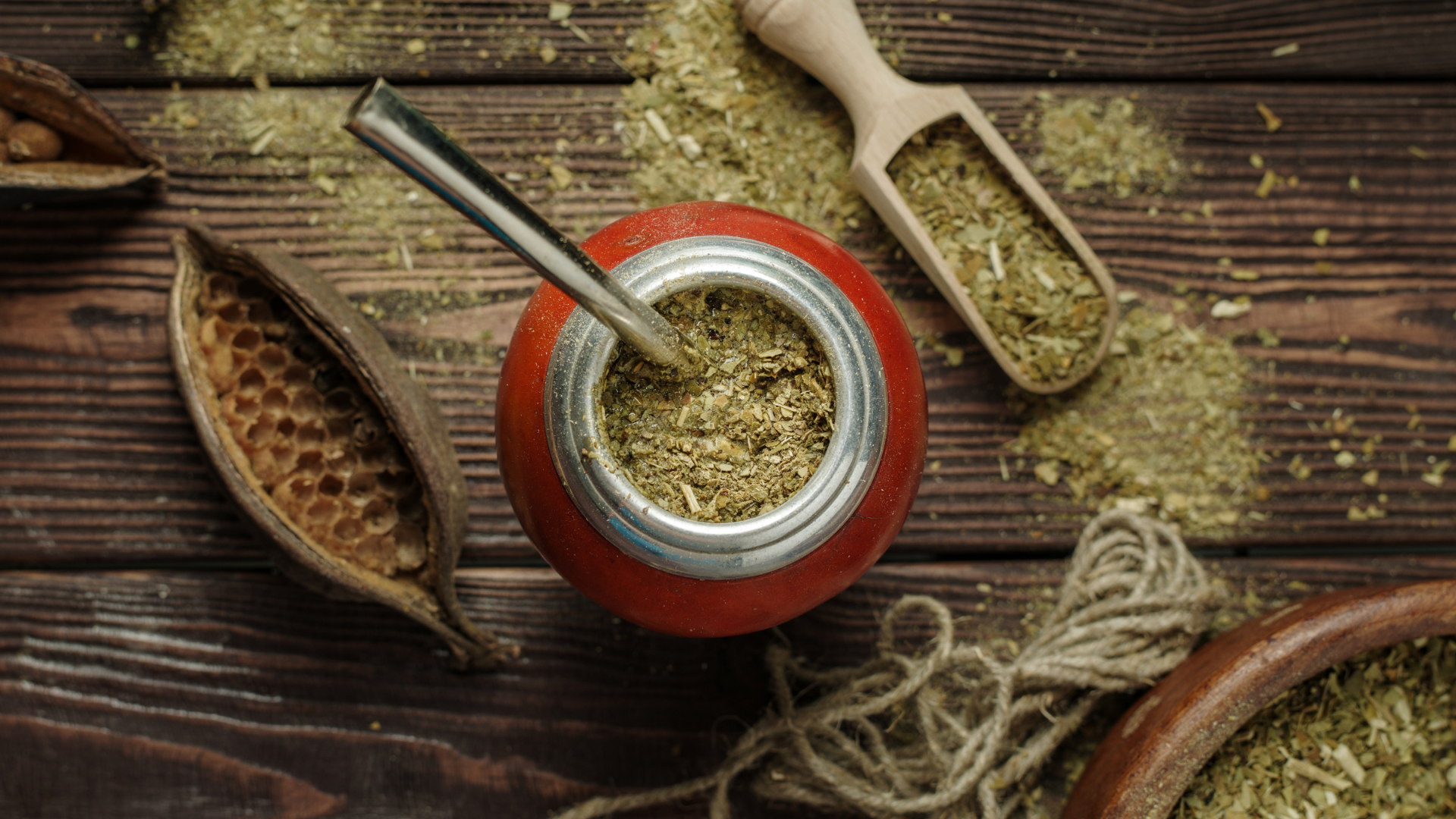 Yerba mate gourd with mate and bomilla on a wood plank background