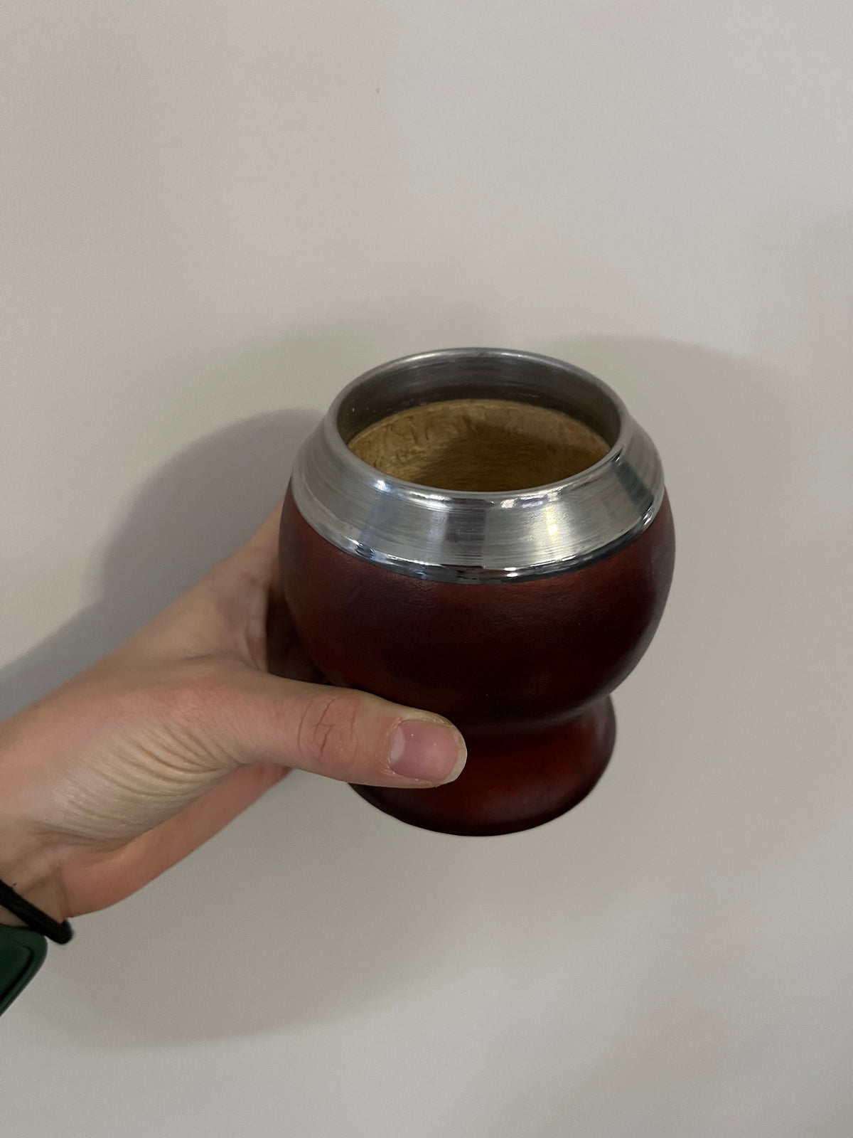 Brown leather-wrapped calabash mate cup from the Maui Mate Starter Kit, held in hand